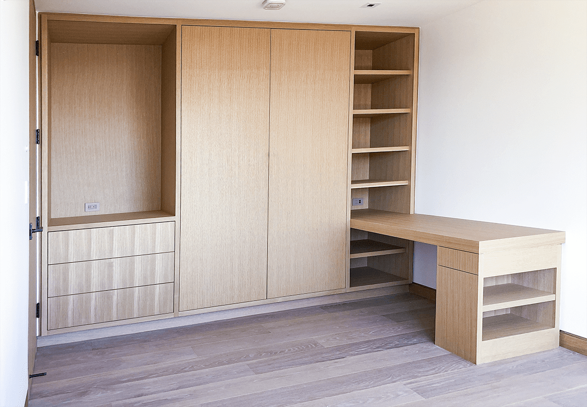Custom light wood built-in cabinetry with integrated desk